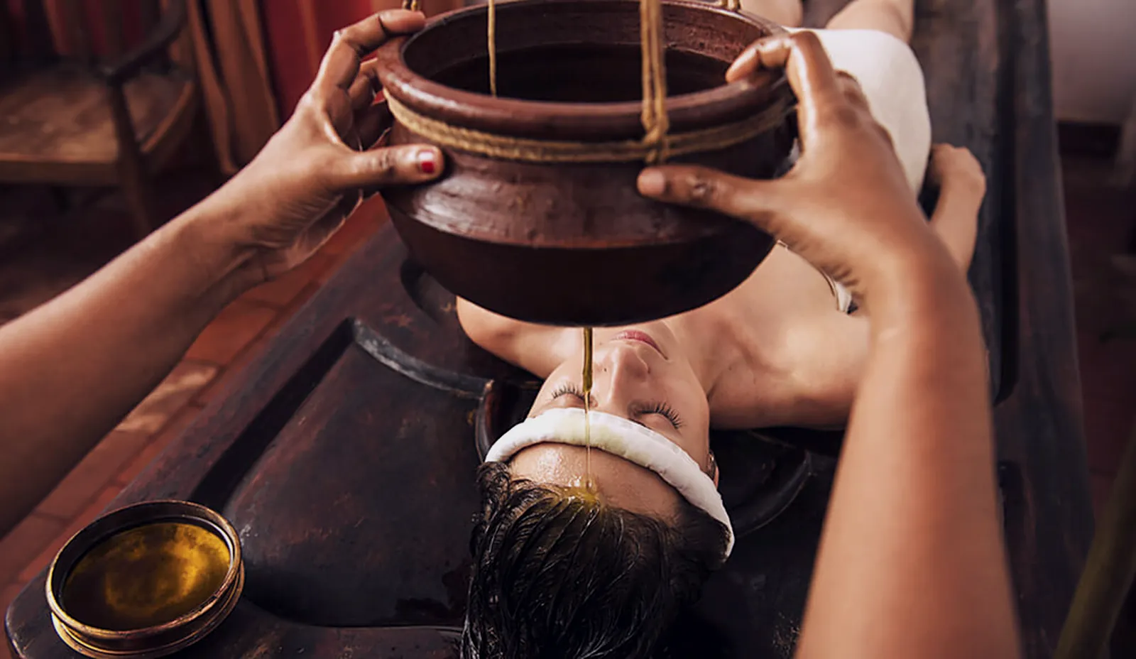 Stream poured onto the forehead from a clay vessel
