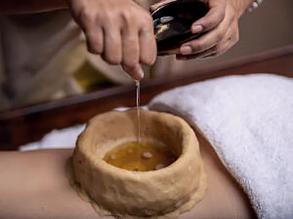Warm oil held in a dough ring on the lower back